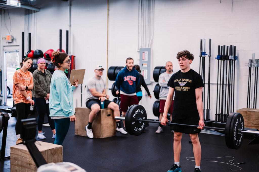 Athlete lifting weights in CrossFit gym.